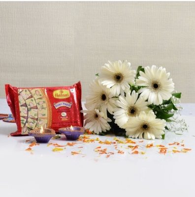 Soan Papdi With White Gerberas Bunch And Diyas